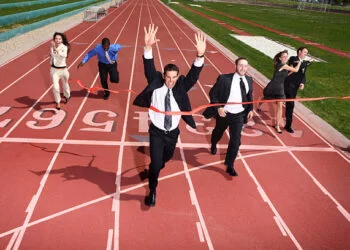 business persons running on a track field