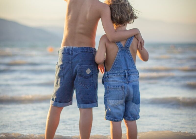 boy and girl standing at beach