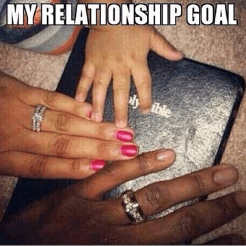 Father, mother, and child touching the Holy Bible