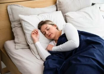 a woman sleeping calmly in bed