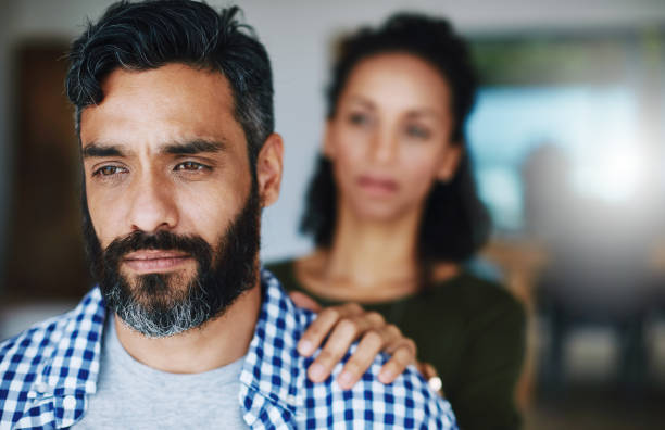 A woman holding her unhappy husband
