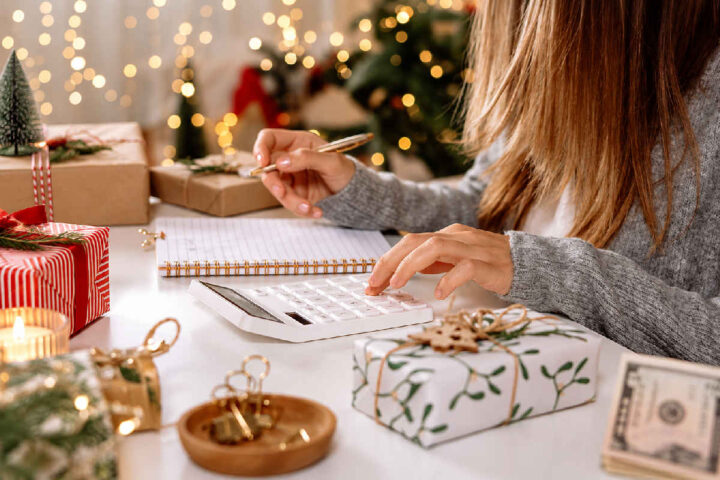 a woman making a holiday budget